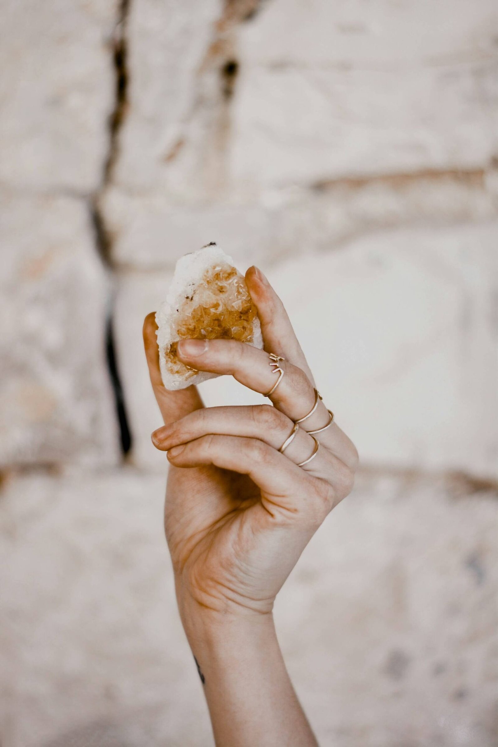 woman's hand holding a citrine crystal
